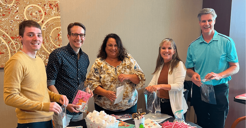 Volunteers and staff collaborate during a community service event, assembling care kits together.